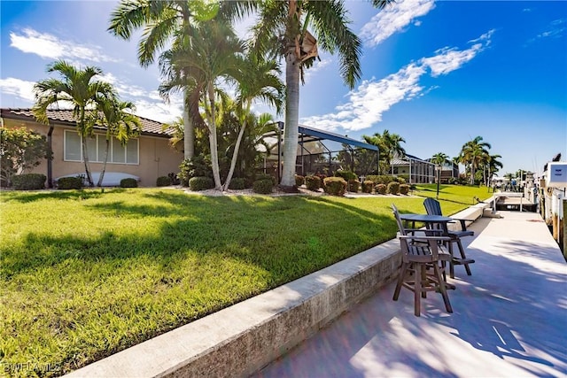 view of property's community with a yard and a patio