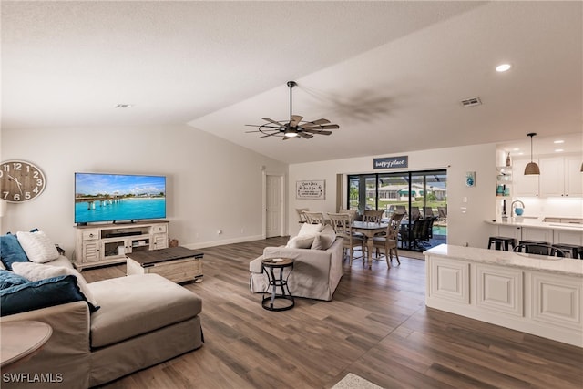 living room featuring lofted ceiling, wood-type flooring, sink, and ceiling fan