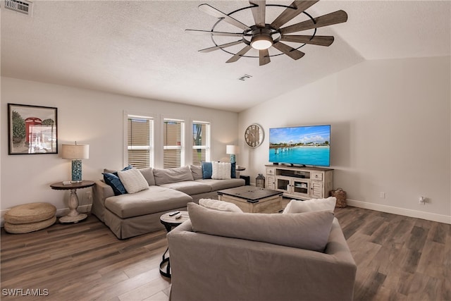 living room with vaulted ceiling, a textured ceiling, ceiling fan, and hardwood / wood-style floors