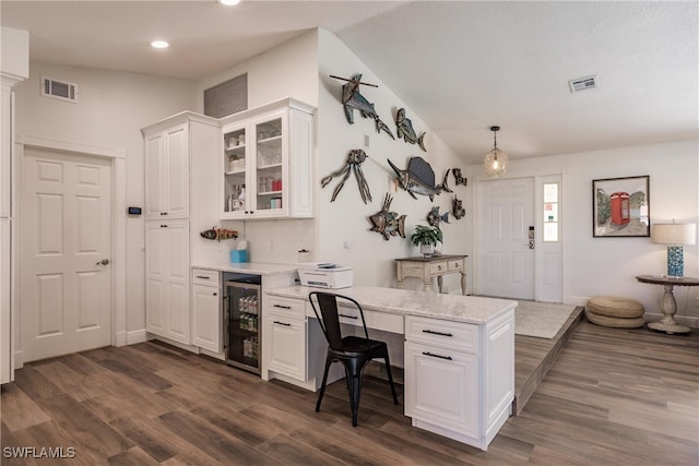 kitchen featuring pendant lighting, light stone countertops, white cabinetry, dark hardwood / wood-style flooring, and wine cooler