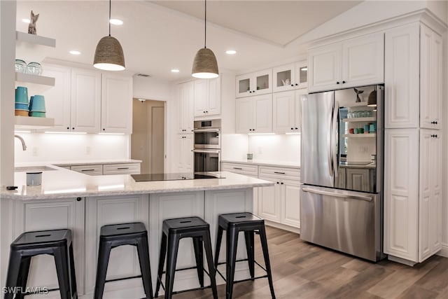 kitchen with appliances with stainless steel finishes, white cabinetry, and dark wood-type flooring