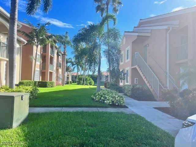 view of home's community with a yard