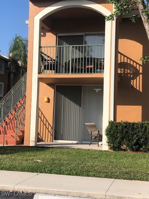 back of house with a balcony