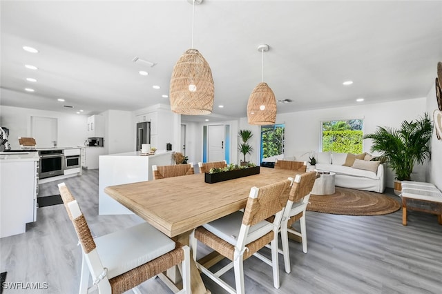 dining area featuring light wood-style flooring and recessed lighting