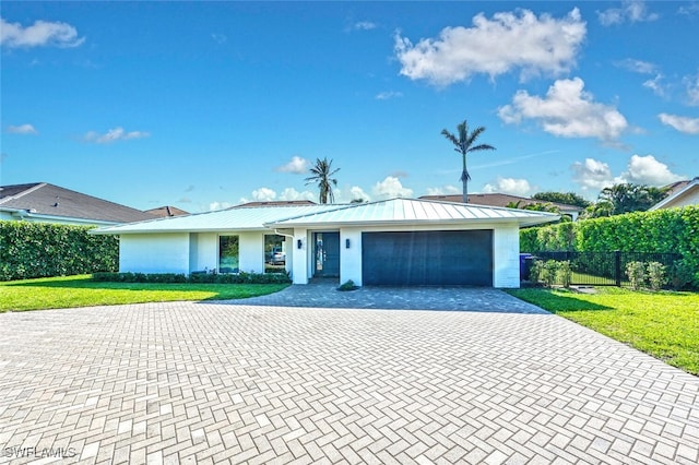 single story home with a garage and a front yard