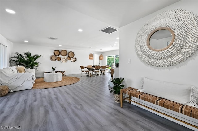 living area featuring recessed lighting, visible vents, and wood finished floors