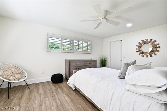 bedroom featuring light hardwood / wood-style flooring and ceiling fan