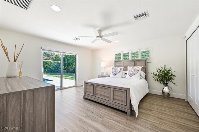 bedroom featuring ceiling fan, light hardwood / wood-style floors, multiple windows, and access to outside