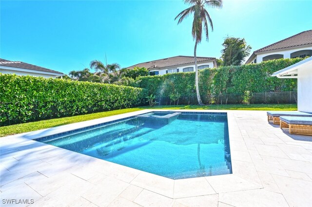 view of pool featuring a patio and an in ground hot tub