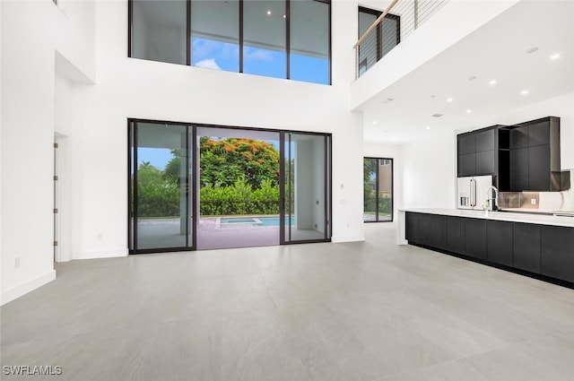 unfurnished living room with a high ceiling