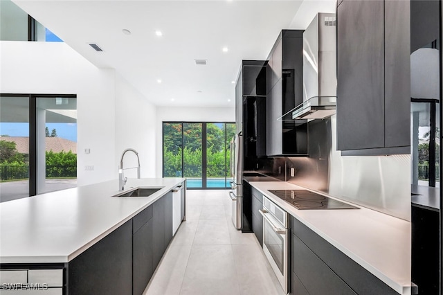 kitchen featuring light countertops, appliances with stainless steel finishes, modern cabinets, and a sink