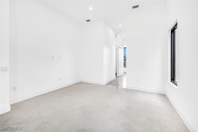 unfurnished room with light colored carpet