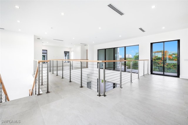 interior space featuring visible vents, an upstairs landing, and recessed lighting