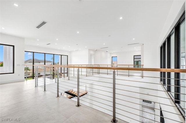 hall featuring visible vents and recessed lighting