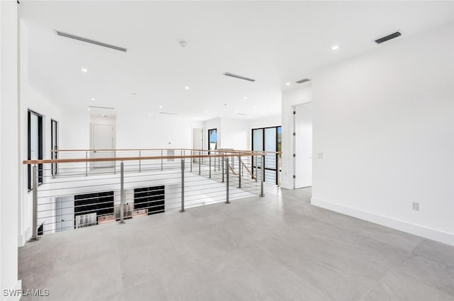 unfurnished living room with recessed lighting, visible vents, and baseboards