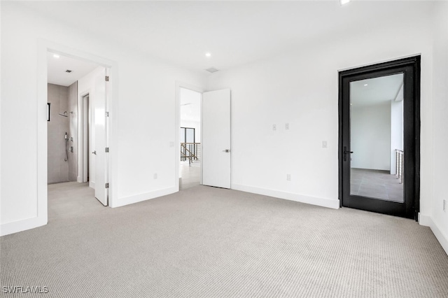 unfurnished bedroom with recessed lighting, light carpet, and baseboards