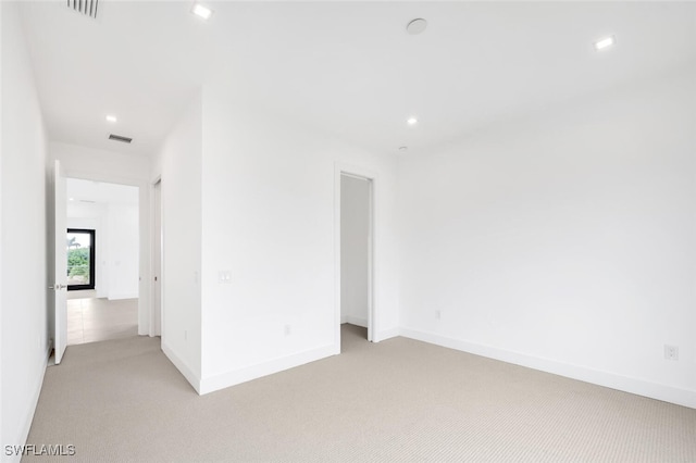 spare room with light carpet, baseboards, visible vents, and recessed lighting