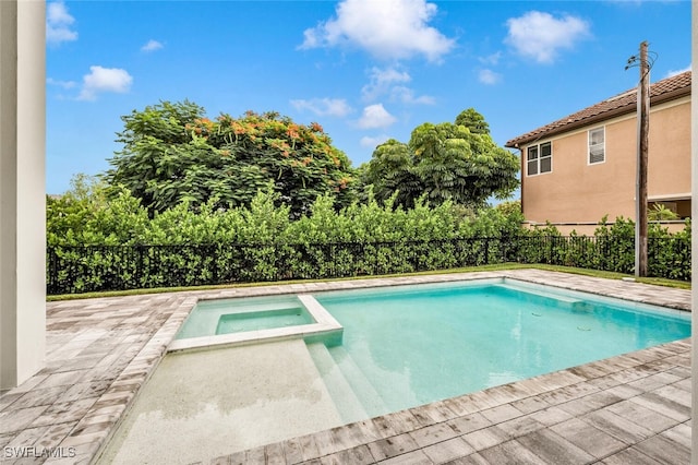 view of swimming pool with an in ground hot tub and a patio