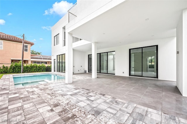 view of swimming pool with an in ground hot tub and a patio