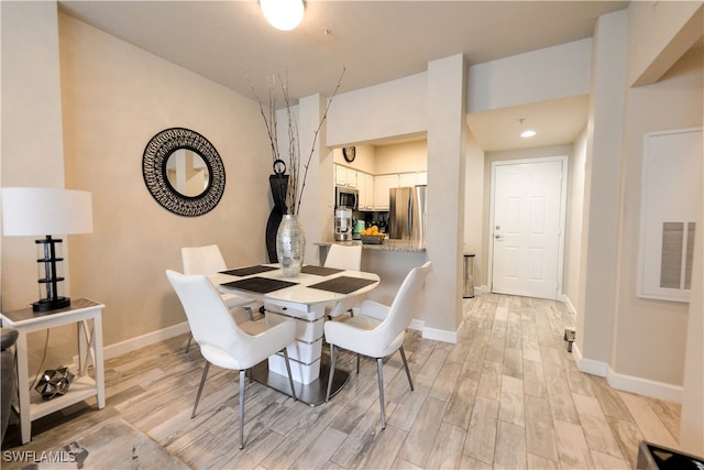 dining space featuring light hardwood / wood-style flooring