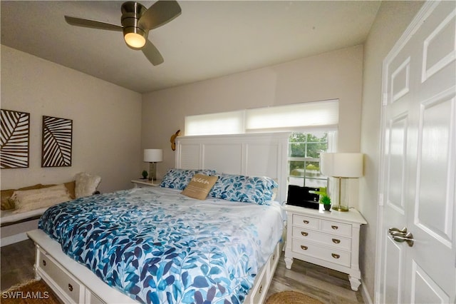 bedroom featuring ceiling fan and dark wood-type flooring