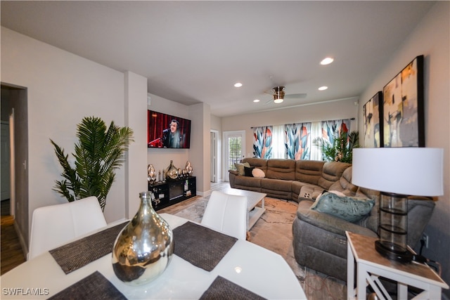 living room with ceiling fan and light wood-type flooring