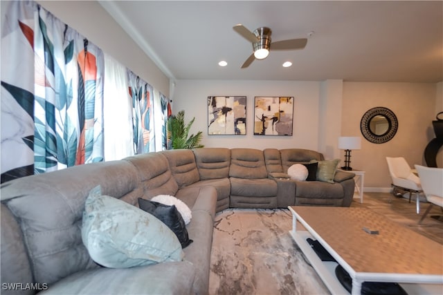 living room featuring ceiling fan and light hardwood / wood-style floors