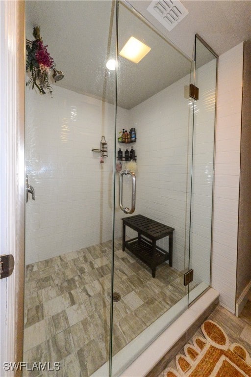 bathroom featuring tile patterned floors and an enclosed shower