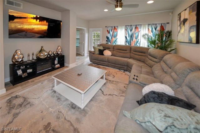 living room featuring ceiling fan and hardwood / wood-style flooring