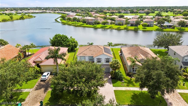 birds eye view of property with a water view and a residential view