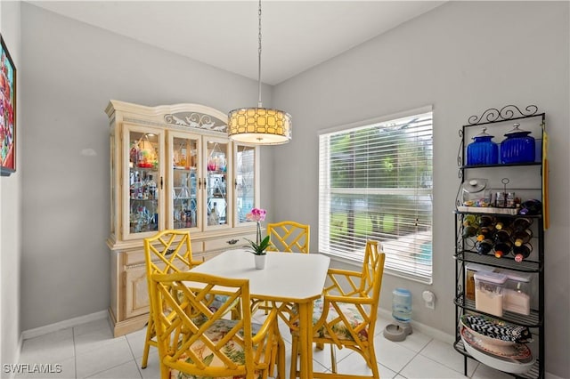 dining space with baseboards and light tile patterned floors