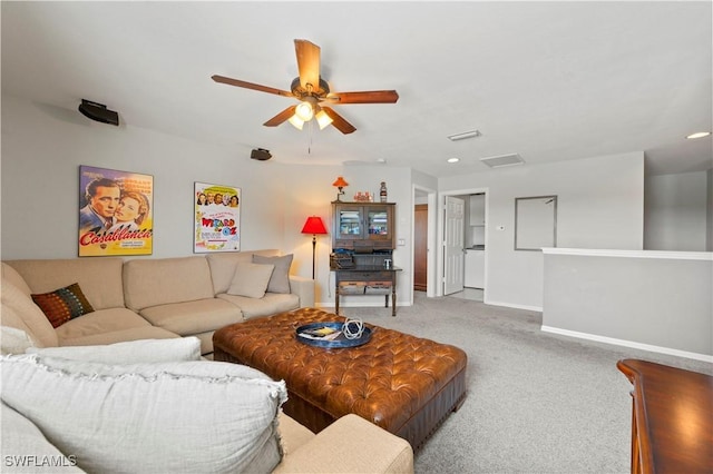 living area with ceiling fan, carpet flooring, and baseboards