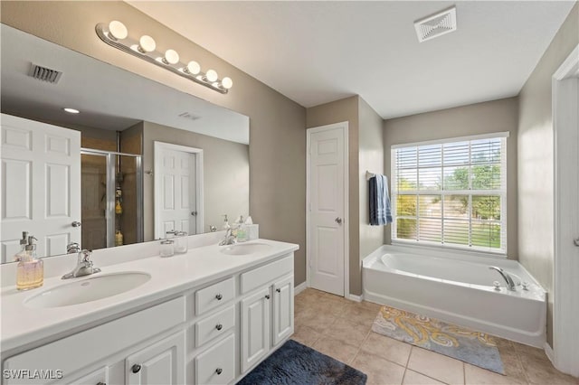 full bath with a garden tub, double vanity, a sink, and visible vents