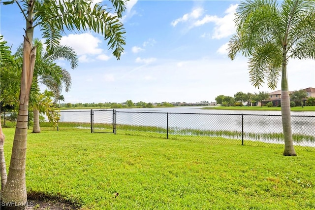 view of yard featuring a water view and fence