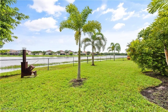 view of yard with a water view and fence