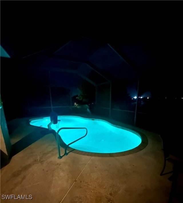 view of pool at night