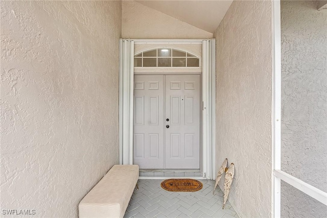 doorway to property featuring stucco siding