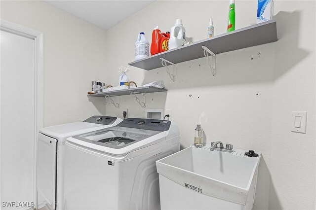 laundry room with sink and washer and clothes dryer