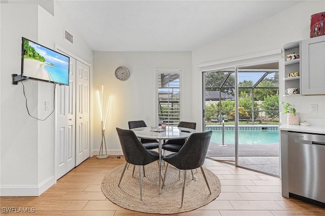 dining space with visible vents, light wood-style flooring, and baseboards