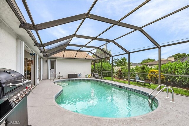 view of swimming pool with a lanai and a patio