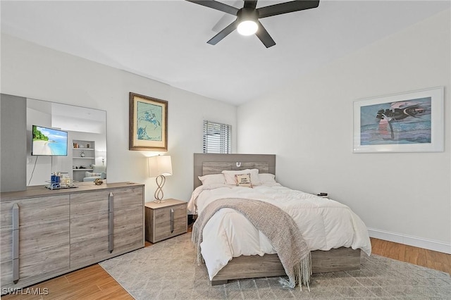 bedroom featuring light wood-style floors, ceiling fan, and baseboards