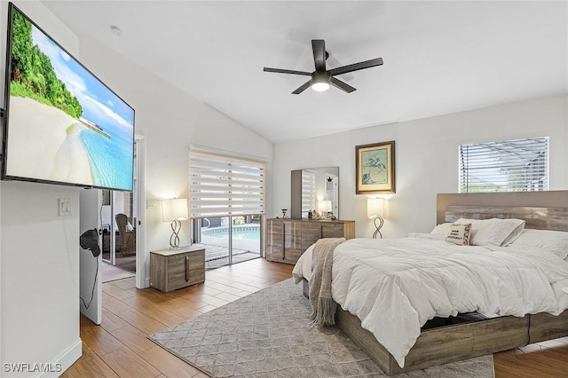 bedroom with access to exterior, vaulted ceiling, ceiling fan, and wood finished floors