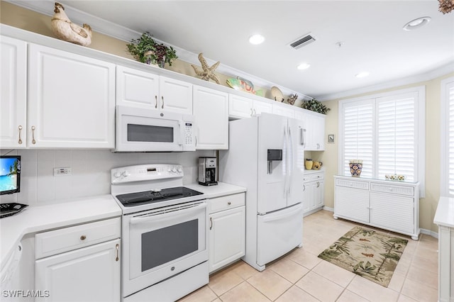 kitchen featuring white cabinets, decorative backsplash, white appliances, and light tile patterned floors