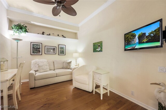 living room with ornamental molding, dark hardwood / wood-style floors, and ceiling fan