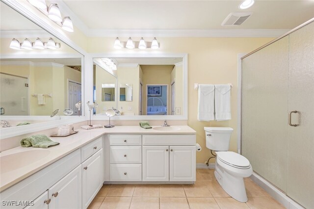 bathroom with toilet, tile patterned floors, an enclosed shower, ornamental molding, and dual bowl vanity