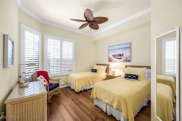 bedroom featuring ceiling fan, wood-type flooring, and ornamental molding