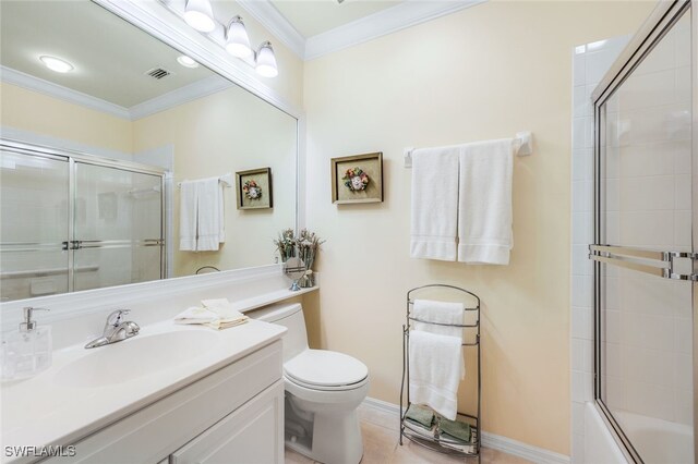 full bathroom with toilet, crown molding, bath / shower combo with glass door, tile patterned flooring, and vanity