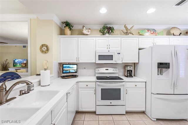 kitchen featuring white appliances, sink, white cabinets, and light tile patterned floors