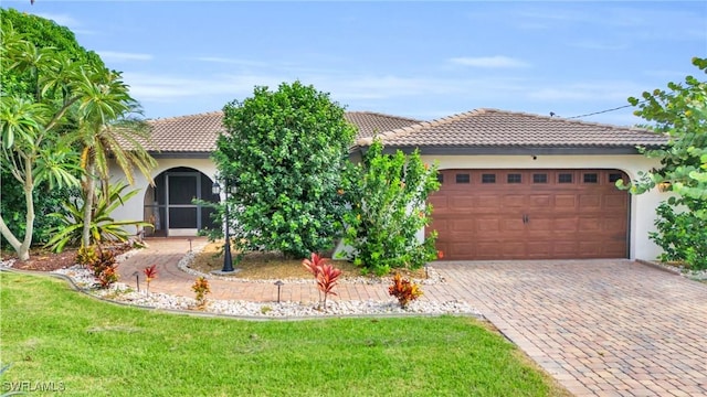 mediterranean / spanish-style house with a garage and a front yard