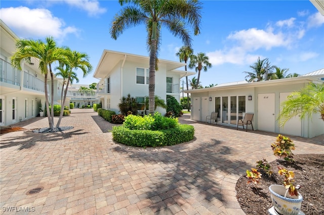 view of front of home featuring a balcony and a patio area